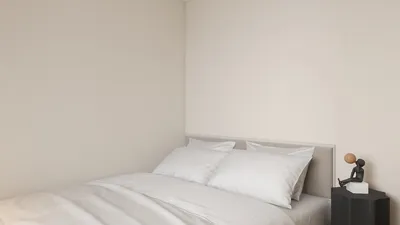 bedroom with a neatly made bed featuring white linens and decorative pillows, showcasing modern interior design style, ideal for restful sleep and relaxation, utilizing Homestyler's real-time 3D rendering feature for instant visual previews.
