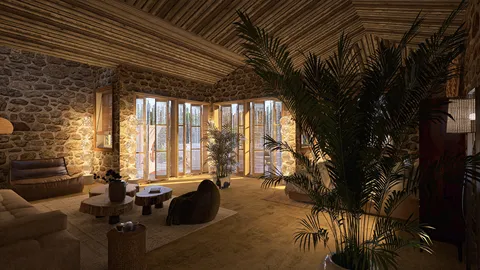 Cozy living room with stone walls and wooden ceiling, showcasing natural light ambiance and modern rustic design, highlighting Homestyler's real-time 3D rendering feature for effective interior visualization.